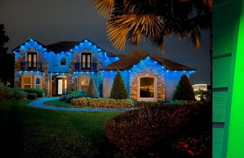 Stone home with Brighter Nights by TrueSpec roofline lighting in blue
